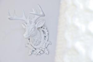 a white wall mount of a deer with antlers at Hotel La Villa Nice Victor Hugo in Nice