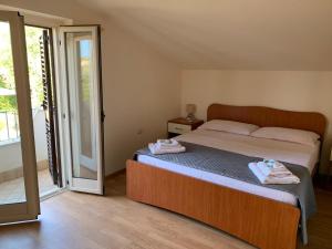 a bedroom with a bed with two towels on it at B&B Collemare in Drapia