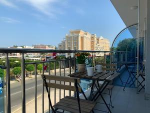 a balcony with a table and chairs on a balcony at Persani Sunny Beach in Sunny Beach