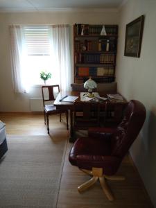 a living room with a desk and a chair and a table at Peaceful Farm in Bøstad