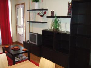 a living room with a entertainment center with a television at Apartamento en 1ª línea de la Playa de Covas - Viveiro (Lugo) in Viveiro