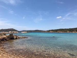 a beach with a person swimming in the water at Abbronzatissima in Trapani