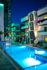 a swimming pool in front of a building at night at Boutique Apartments Blitz in Bibinje