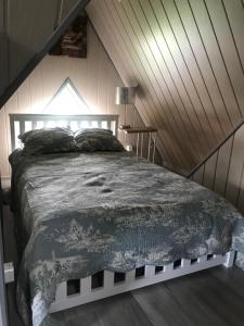 a bedroom with a large bed in a attic at Apartament Roti Solina in Solina