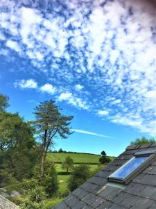 a blue sky with clouds above a roof at Heddfan (Place of Peace) in Llanboidy