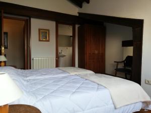 a bedroom with a large white bed in it at La Carriella in Colombres