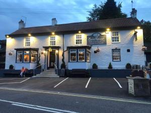 a white building with a sign on the front of it at The Boathouse Wylam in Wylam