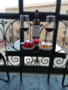 a table with two glasses of wine and a plate of food at Mirador de Cristal-Centro-parking - 2 habitaciones-2 baños in Soria