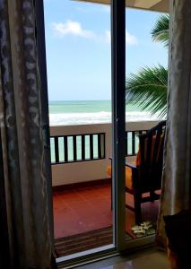 a room with a view of the ocean from a balcony at La Veranda Di Serena in Unawatuna