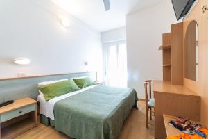 Postel nebo postele na pokoji v ubytování Hotel Augusta