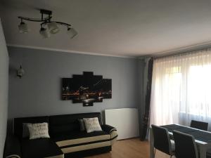 a living room with a couch and a table at Wygodny Apartament in Gdynia