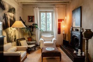 a living room with a couch and chairs and a fireplace at La Maison at The Old Bridge in Florence