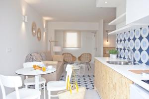 a kitchen and living room with a table and chairs at BJ Cala Morlanda Estudios in S'Illot