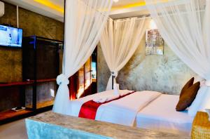 a bedroom with two beds with curtains and a television at Khum Lanna Boutique Hotel in Si Sa Ket +154 photos