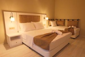 A bed or beds in a room at Ayvalık Sea Resort