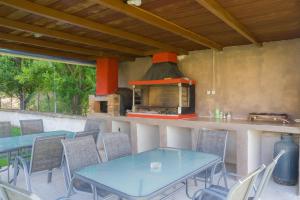 a kitchen with a table and chairs and an oven at Kremasti Rooms in Kremastí