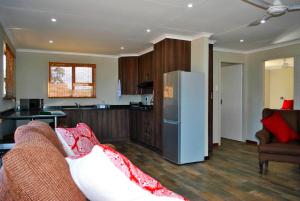 a living room with a couch and a refrigerator at Forest View Cabins in Tzaneen
