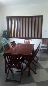 a wooden table with two chairs and a wooden bench at An Phuc Hotel in Vung Tau