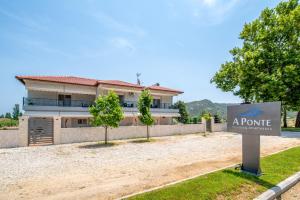 a house with a sign in front of it at A Ponte Studios & Apartments in Sykia Chalkidikis