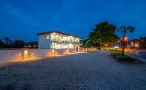 a house on a street at night at A Ponte Studios & Apartments in Sykia Chalkidikis