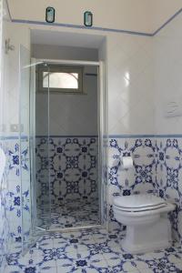 a blue and white bathroom with a toilet and a shower at Villa Flora in Vico Equense +26 photos