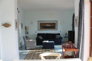 a living room with a couch and a table at Villa Flora in Vico Equense