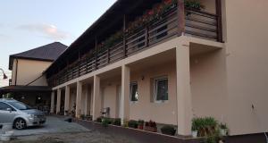 a building with a balcony with plants on it at Air&Day in Vecsés