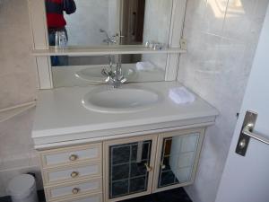 a bathroom with a sink and a mirror at LE BOUT DE LA VILLE in Hirel
