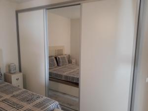 a mirror in a bedroom with a bed in it at De Luxe Apartment South Tenerife in Costa Del Silencio +35 photos