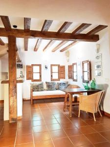 a living room with a couch and a table and chairs at Agroturismo Ca na Joaneta in Santa Eularia des Riu