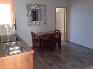 a kitchen and dining room with a table and chairs at Villa M - 4 Persons Apartment, Put in Ljubač