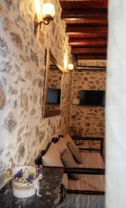 a woman sitting on a bed in a room at Kagiampakis Concept Residences in Avdou