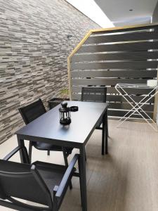 a table and chairs in a room with a brick wall at Oasis in Sarti