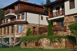 a house with balconies on the side of it at Планински кът in Dorkovo