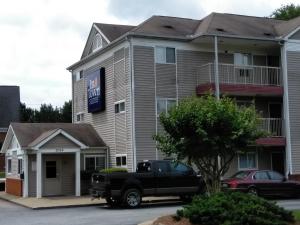 a black truck parked in front of a building at InTown Suites Extended Stay Athens GA - University of Georgia in Athens