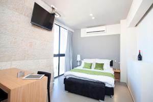 Ένα ή περισσότερα κρεβάτια σε δωμάτιο στο Hillel 11 Hotel