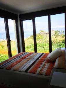 Posteľ alebo postele v izbe v ubytovaní viviendas de uso turístico FINISTERRAE FARO