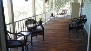 a row of chairs sitting on a porch at Berkshire Inn in Groveland