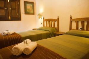 a hotel room with two beds with towels on them at Casa Rural Los Patos in Hermigua