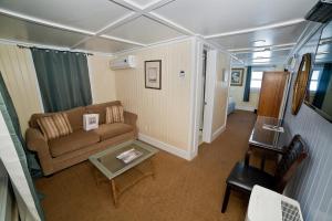 a living room with a couch and a table at Georgianne Inn & Suites check in 212 Bulter Ave in Tybee Island