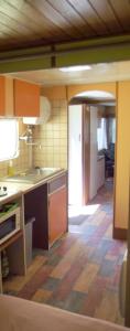 a kitchen with an open door to a room at Mobil-home in Ravières