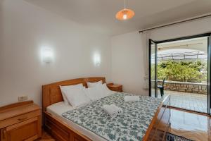 a bedroom with a bed with a glass window at Apartmani Jasna in Herceg-Novi
