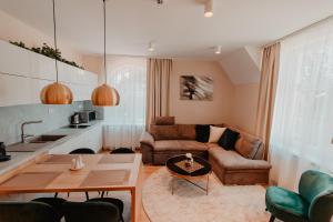 a living room with a couch and a table at Villa Garden Apartments in Poprad