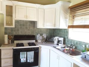 
a kitchen with a stove top oven and a microwave at Bay View condo in Philipsburg
