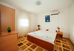 a bedroom with a bed and a window at Apartments Paradise in Ulcinj +51 photos