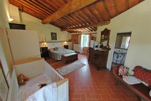 a room with a bedroom with a bed and a desk at La Piaggia in Altopascio +23 photos