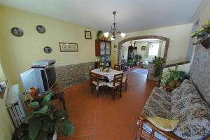 a living room with a couch and a table with a tv at La Piaggia in Altopascio