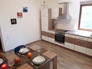 a kitchen with a table and a dining room at House Vedran in Labin