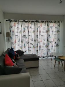 a living room with a couch and a table at appartement vue sur mer in Saint-Jean-de-Monts