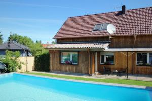 a house with a swimming pool in front of a house at Spreewald Unterkünfte in Briesensee